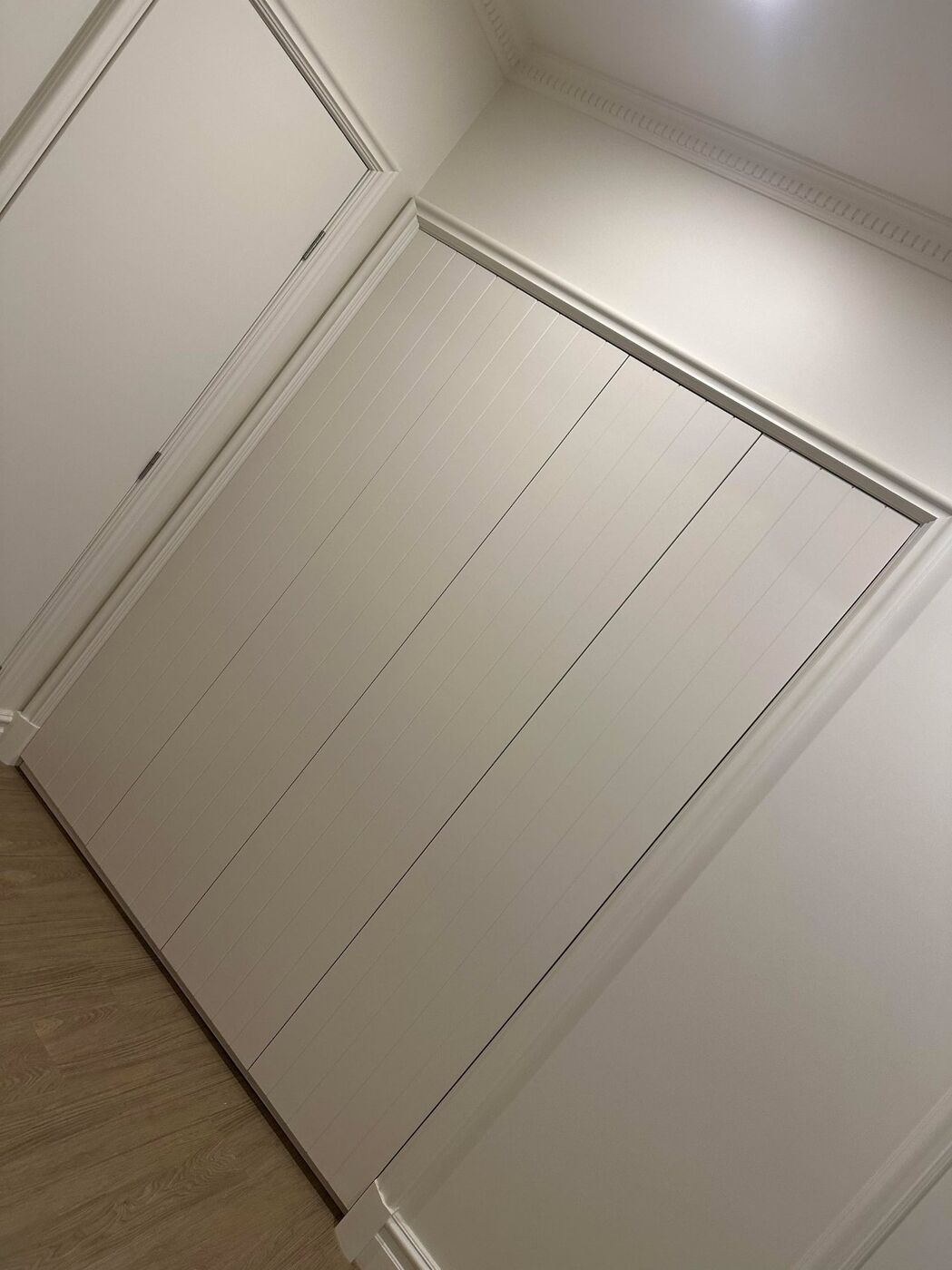 Custom white panelled wardrobe sliding doors fitted floor-to-ceiling