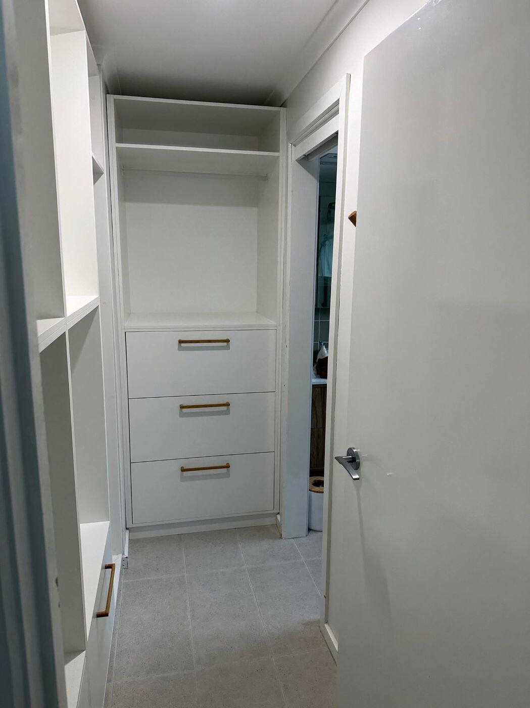 Compact walk-in wardrobe with drawer tower and shelving