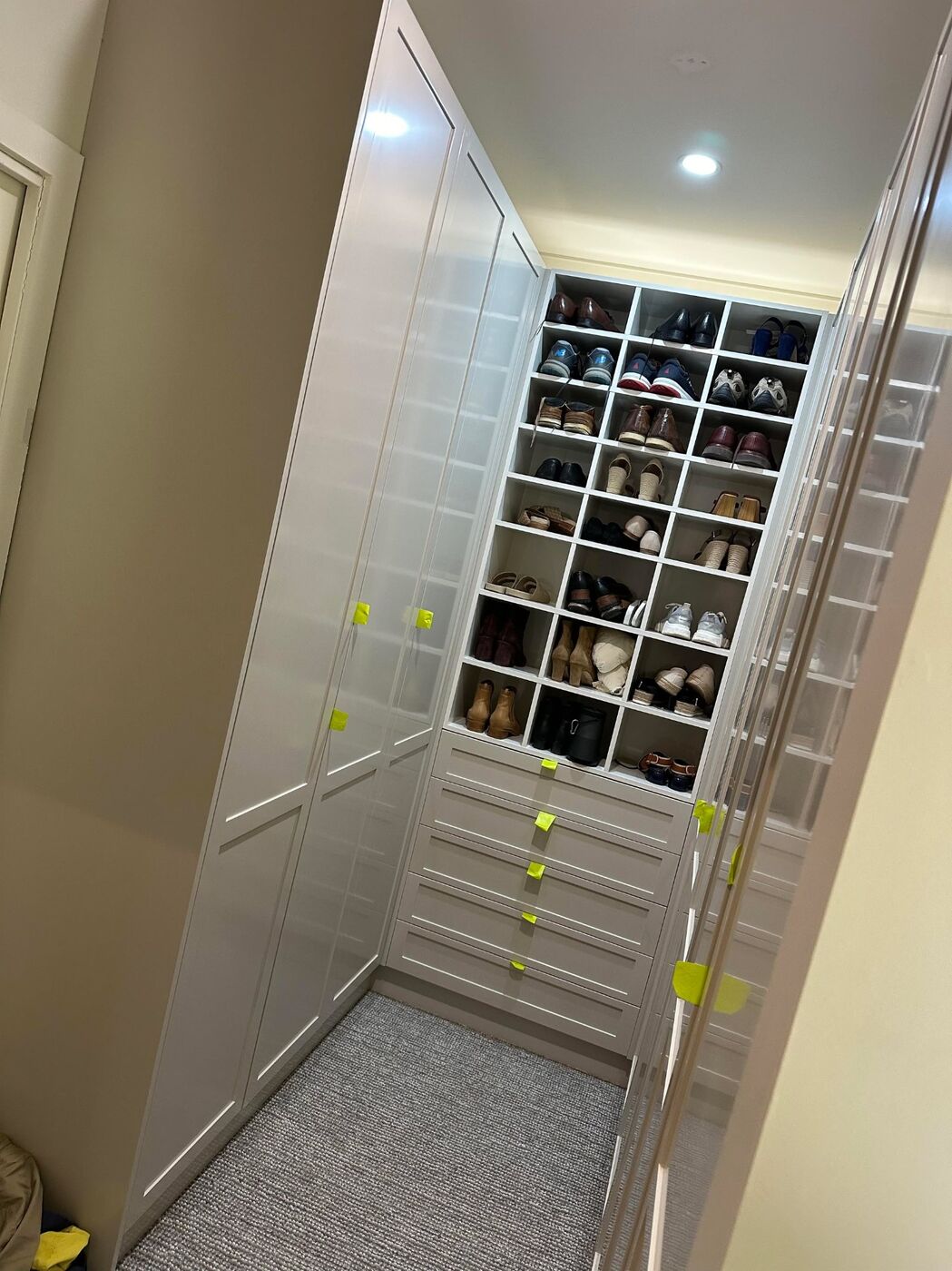 Built-in wardrobe with shoe display cubbies and shaker drawers